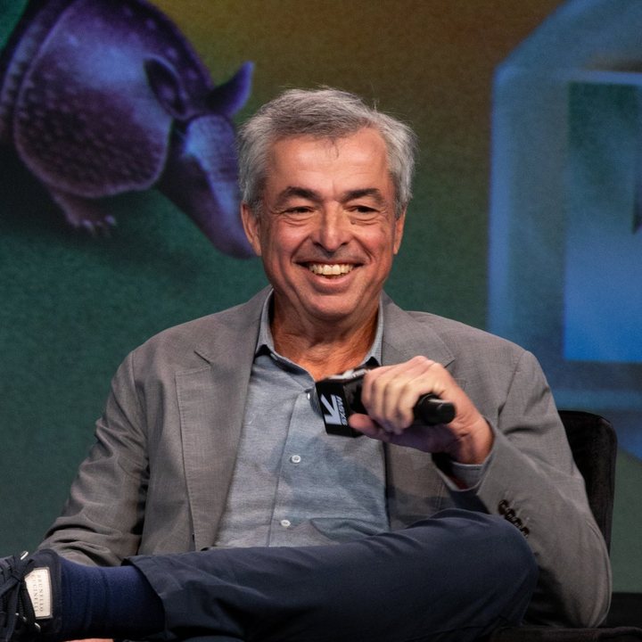 Eddy Cue, Apple's senior vice president of Services, smiling on stage at SXSW 2025 holding a microphone